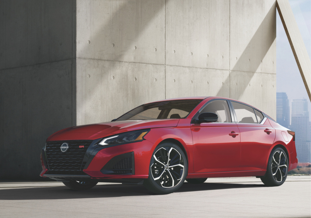 2026 Nissan Altime in the color red in front of an industrial background