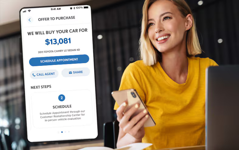 A woman smiling and holding a phone with a screenshot of the Flow Garage mobile app to the left