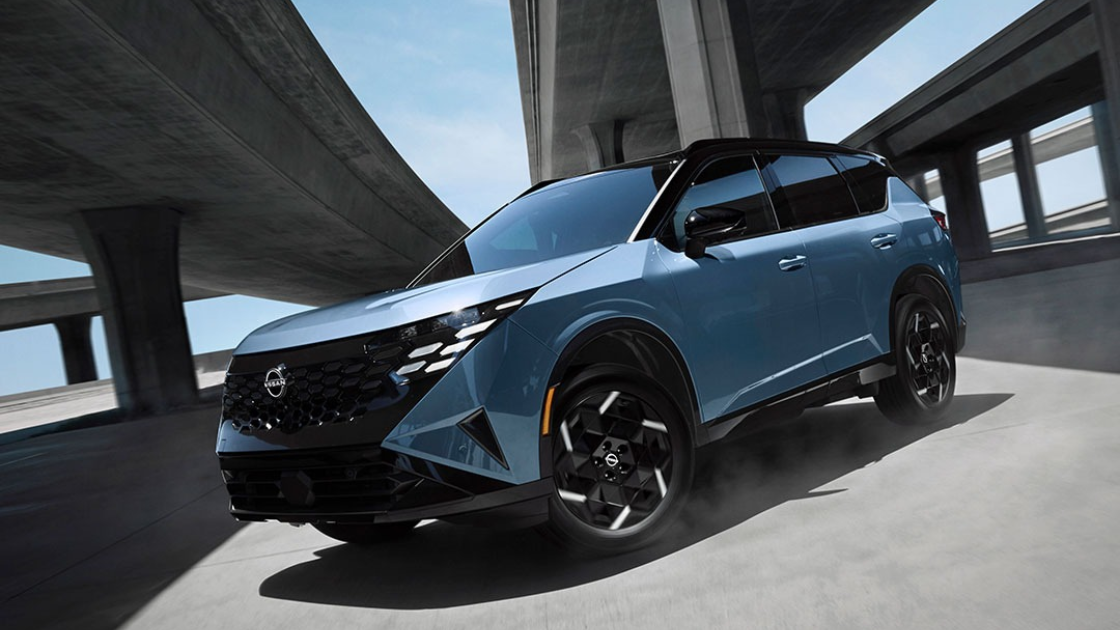 The all-new 2027 Nissan Rogue Hybrid SUV in a dynamic outdoor setting showcasing its sleek design and standard all-wheel drive capability.