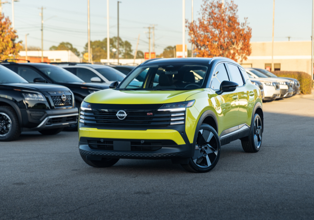Bright yellow 2026 Nissan Kicks in a parking lot with other colors