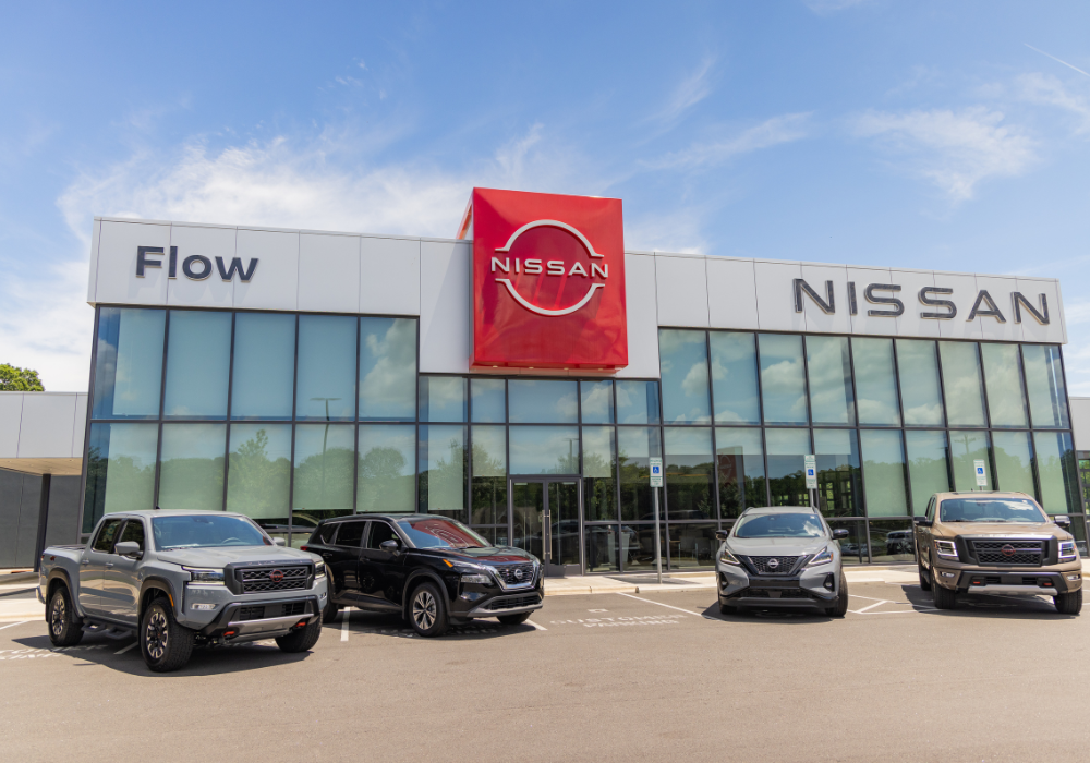 4 Nissan SUVs for sale parked in front of the Flow Nissan of Statesvill dealership.
