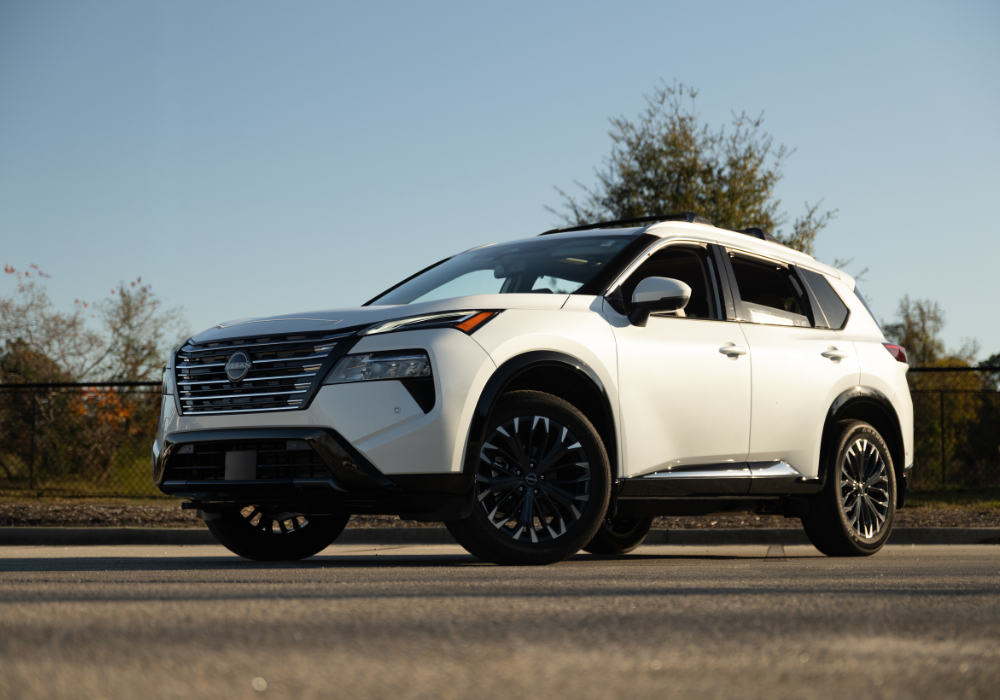 White Nissan Rogue parked in an empty lot