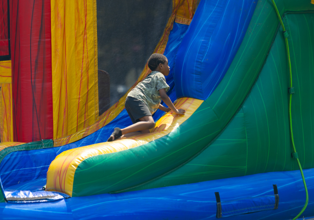 A child playing on an inflatable bouncy castle