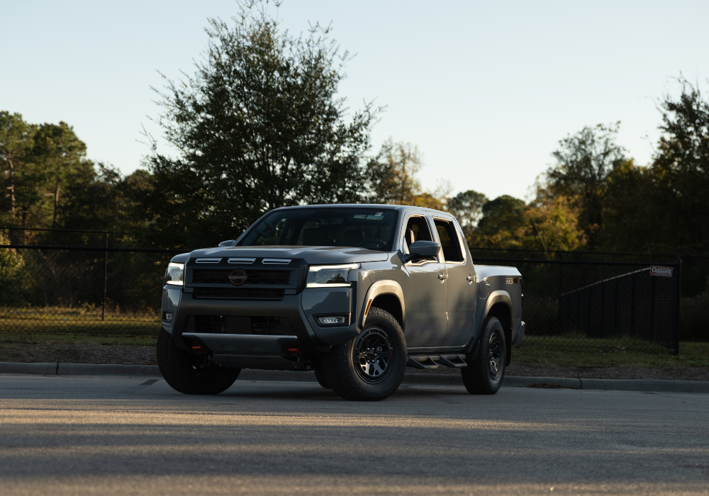 2025 Nissan Frontier truck parked on a paved surface with trees in the background