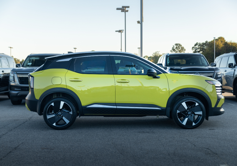 Driver's side view of a 2026 Nissan Kicks in the parking lot of a car dealership